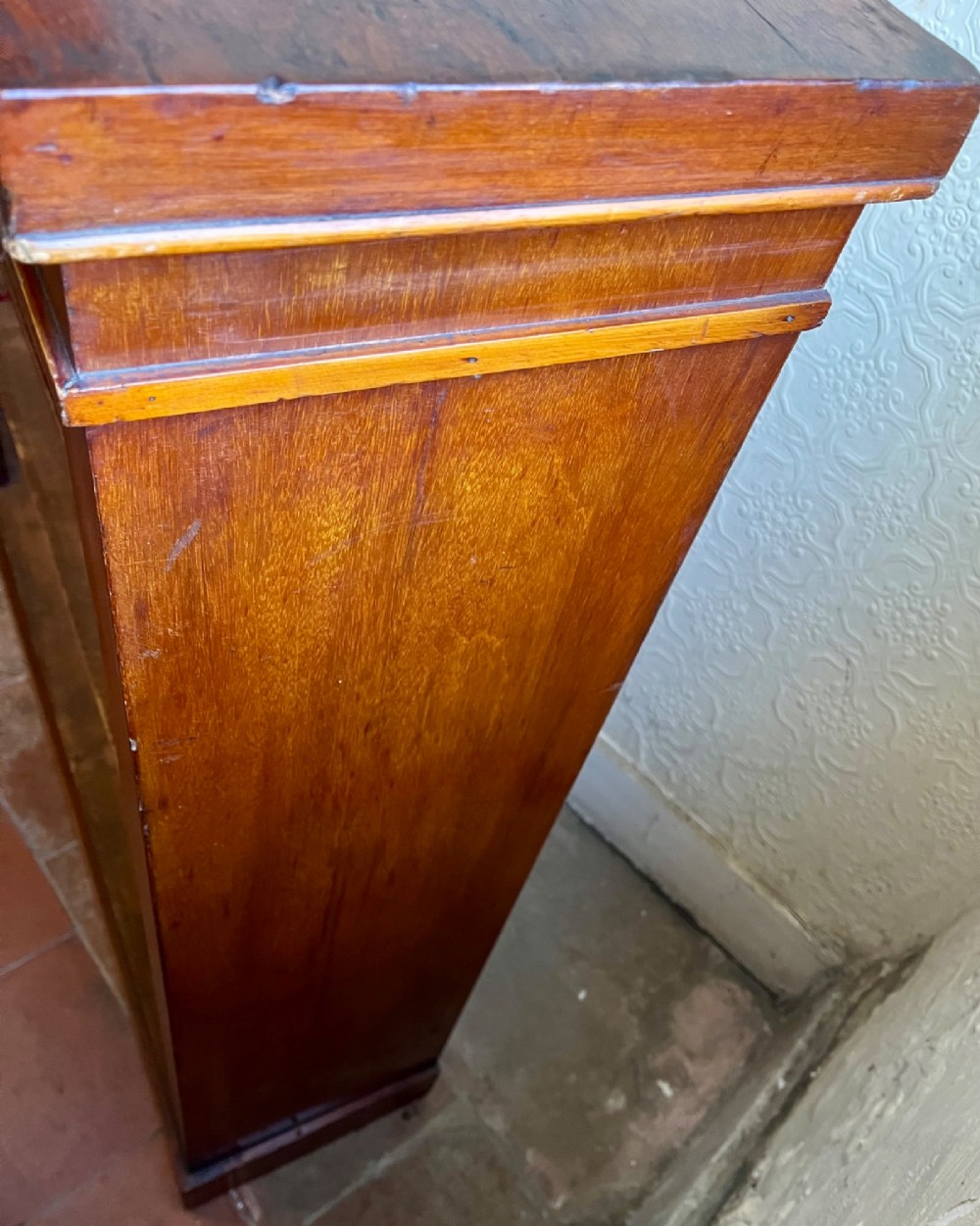 A low Victorian open mahogany bookcase featuring three wide shelves, exposed vertical backboards, a top edge, and a plinth base. View VI