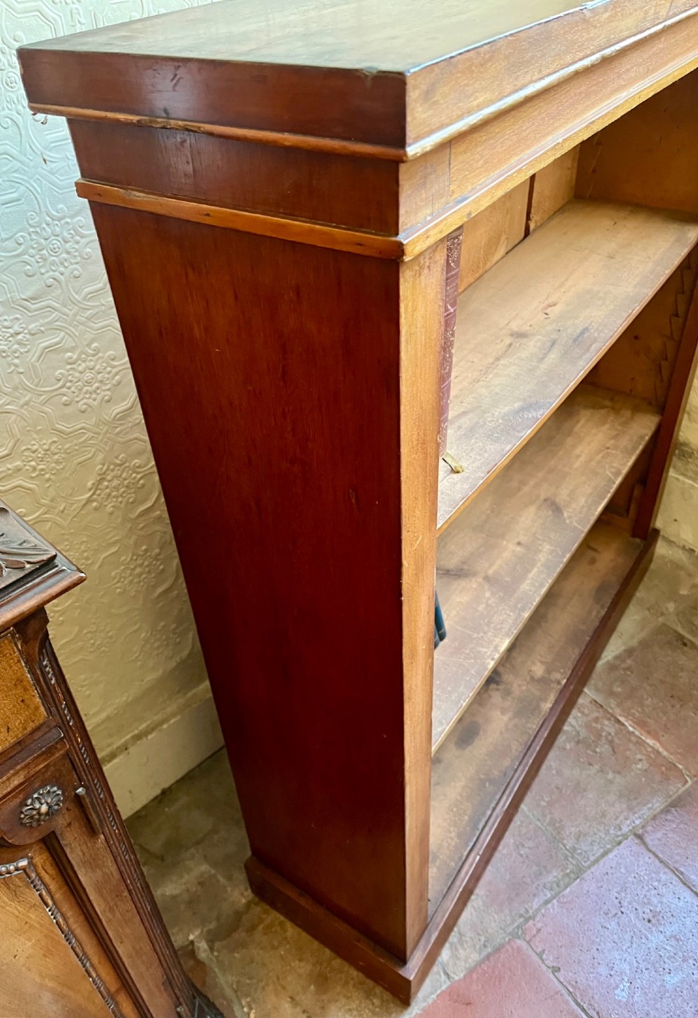 A low Victorian open mahogany bookcase featuring three wide shelves, exposed vertical backboards, a top edge, and a plinth base. View VII