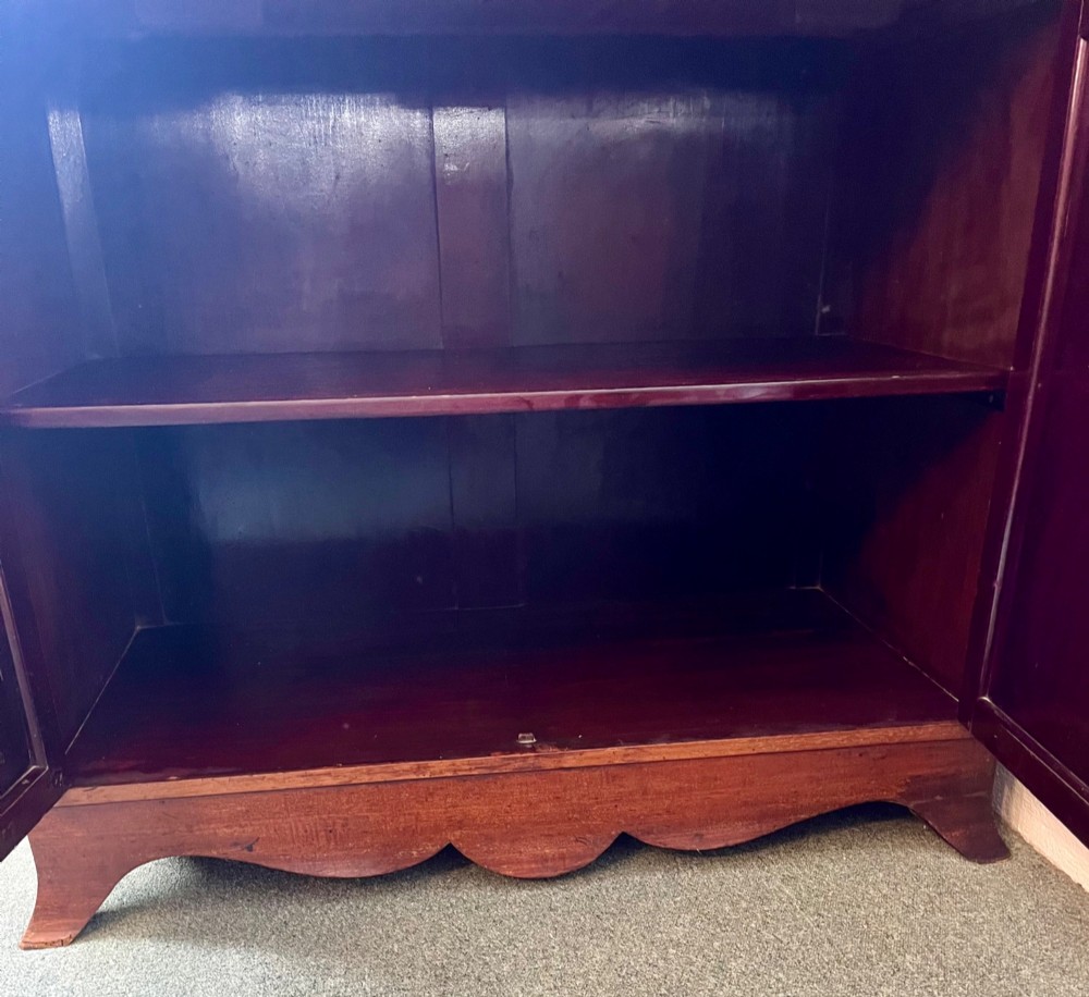 An Edwardian mahogany secretaire bookcase featuring satinwood marquetry inlays, a swan-neck pediment, glazed upper doors, and a pull-out desk drawer above lower cupboards. View VIII