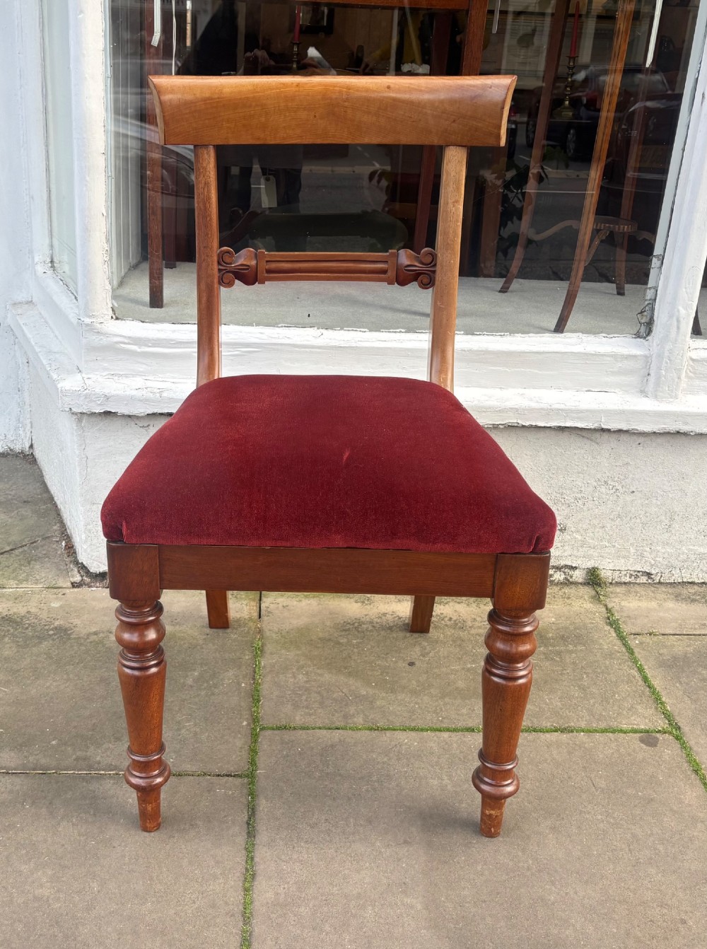 A set of six early Victorian mahogany dining chairs lined up, featuring turned front legs, curved top rails, and red velvet upholstered seats. View VIII