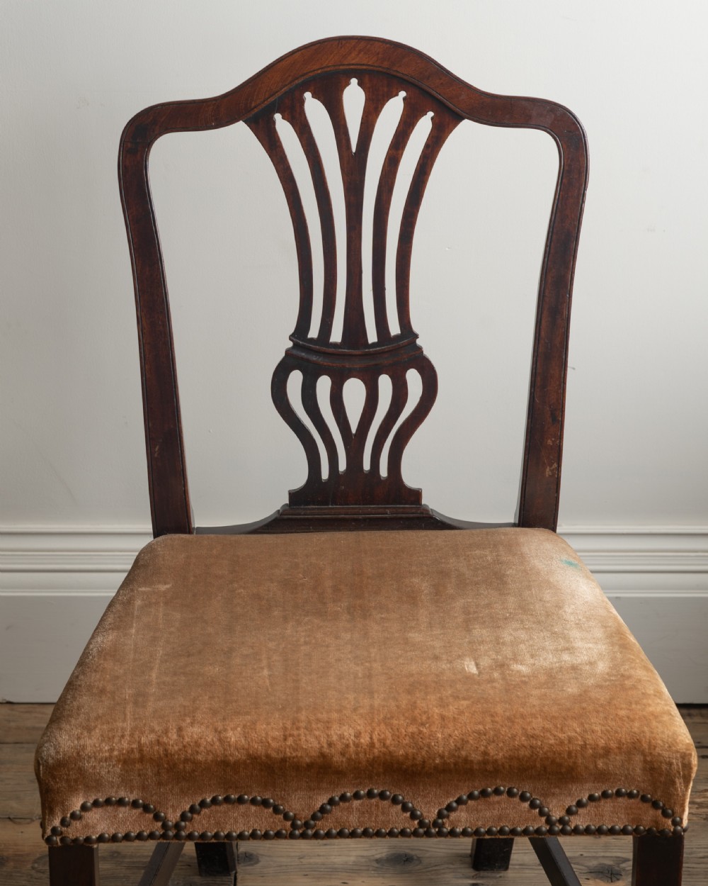 A pair of antique dark mahogany side chairs featuring pierced splats, straight square legs, and brown velvet upholstered seats trimmed with decorative brass studs. View II