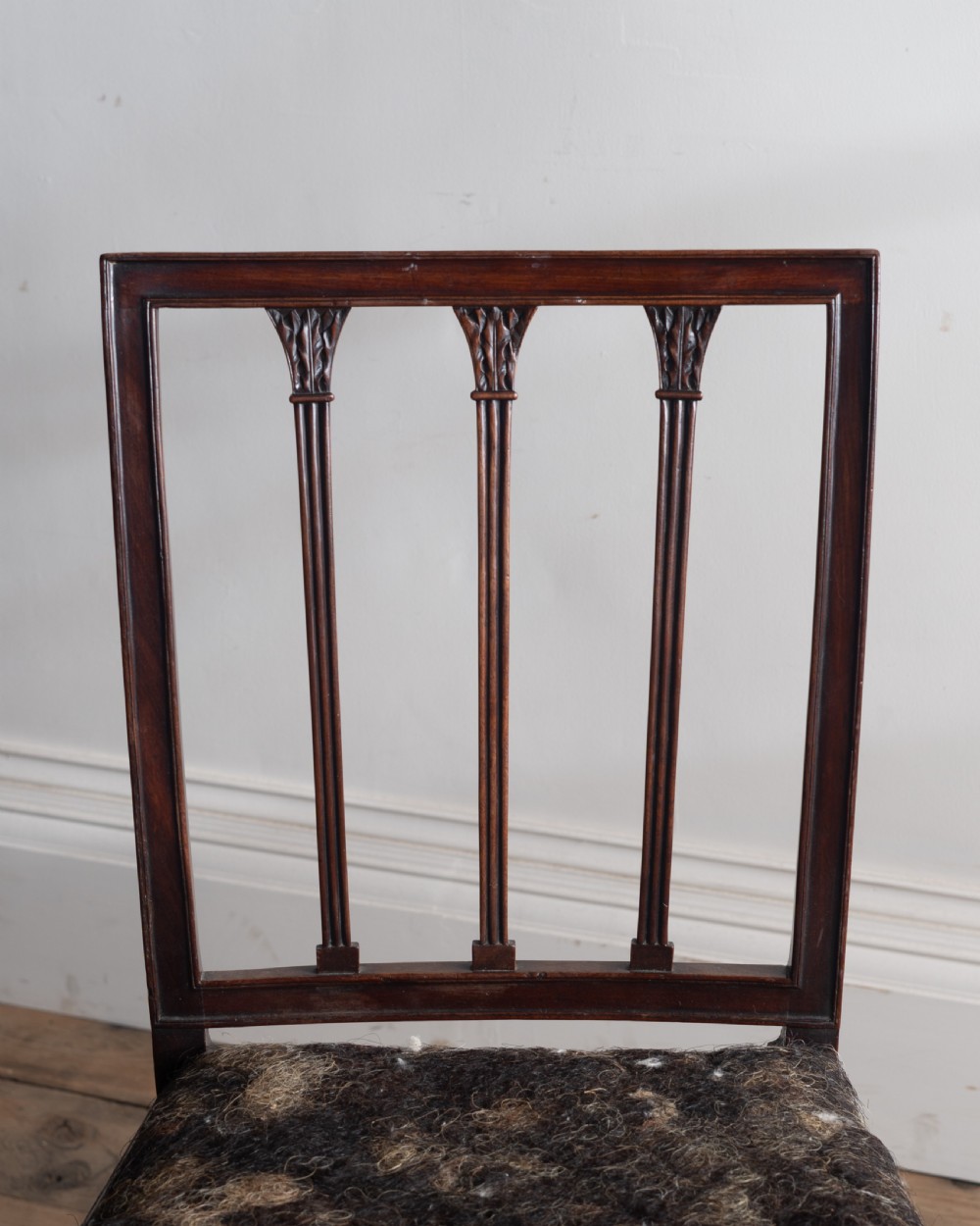 A pair of dark mahogany George III side chairs featuring rectangular backs with vertical reeded splats, square legs, and upholstered drop-in seats. View II