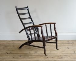 AN ARTS CRAFTS RECLINING ARMCHAIR