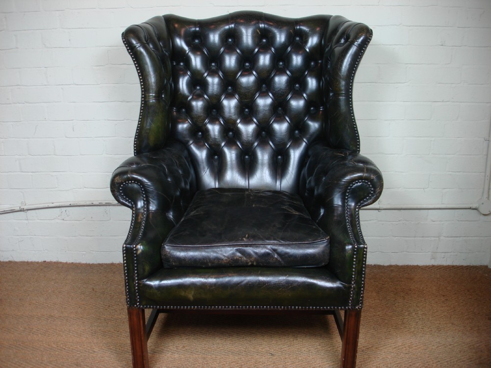Deep buttoned leather wing armchair