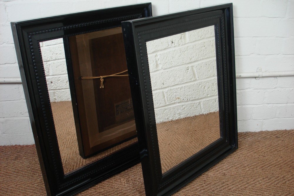 Pair of ebonised frame mirrors