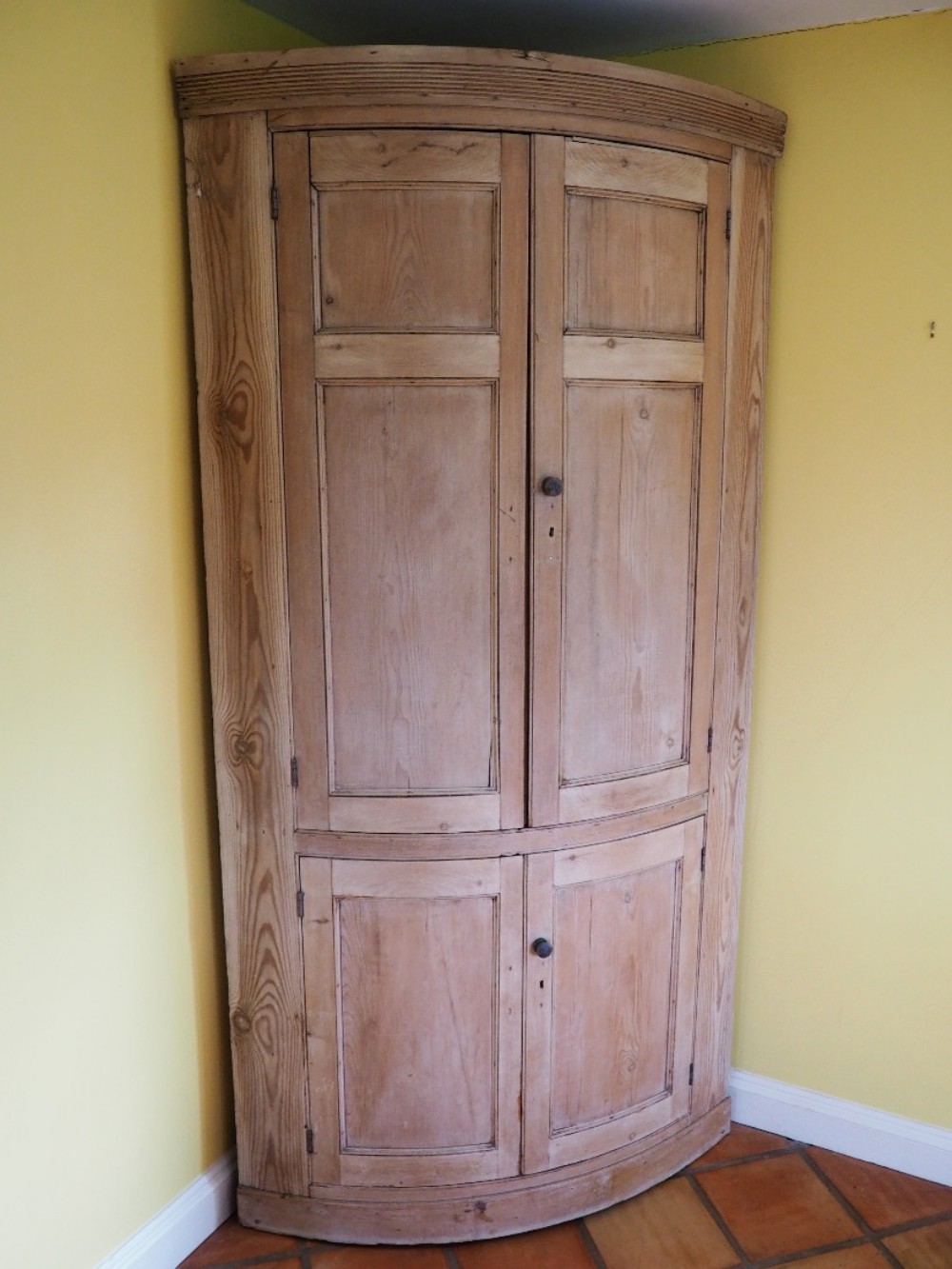 Bowfronted pine corner cupboard