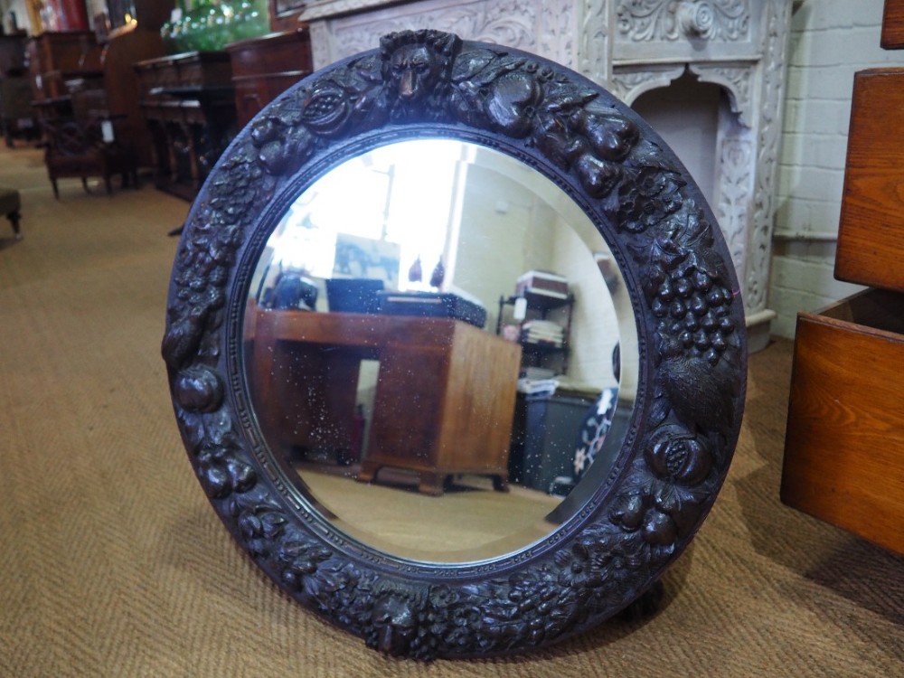 Circular carved oak mirror