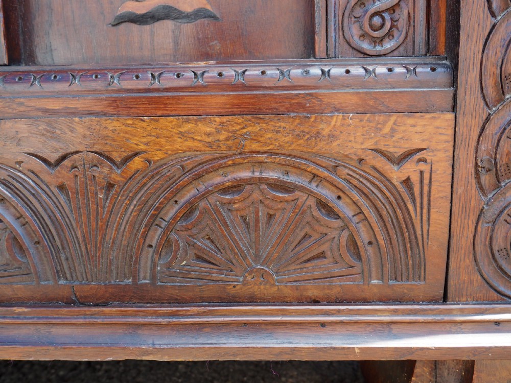 A rectangular carved oak coffer with three arcaded front panels featuring floral inlay and a flat panelled top. View VII