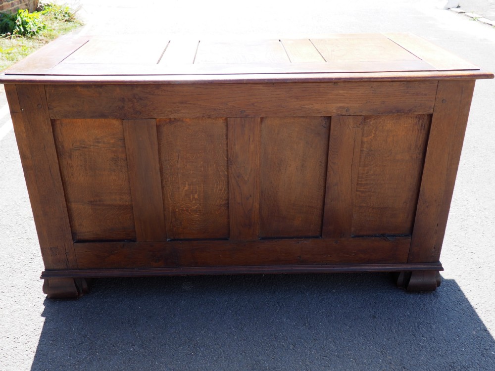 A rectangular carved oak coffer with three arcaded front panels featuring floral inlay and a flat panelled top. View XII