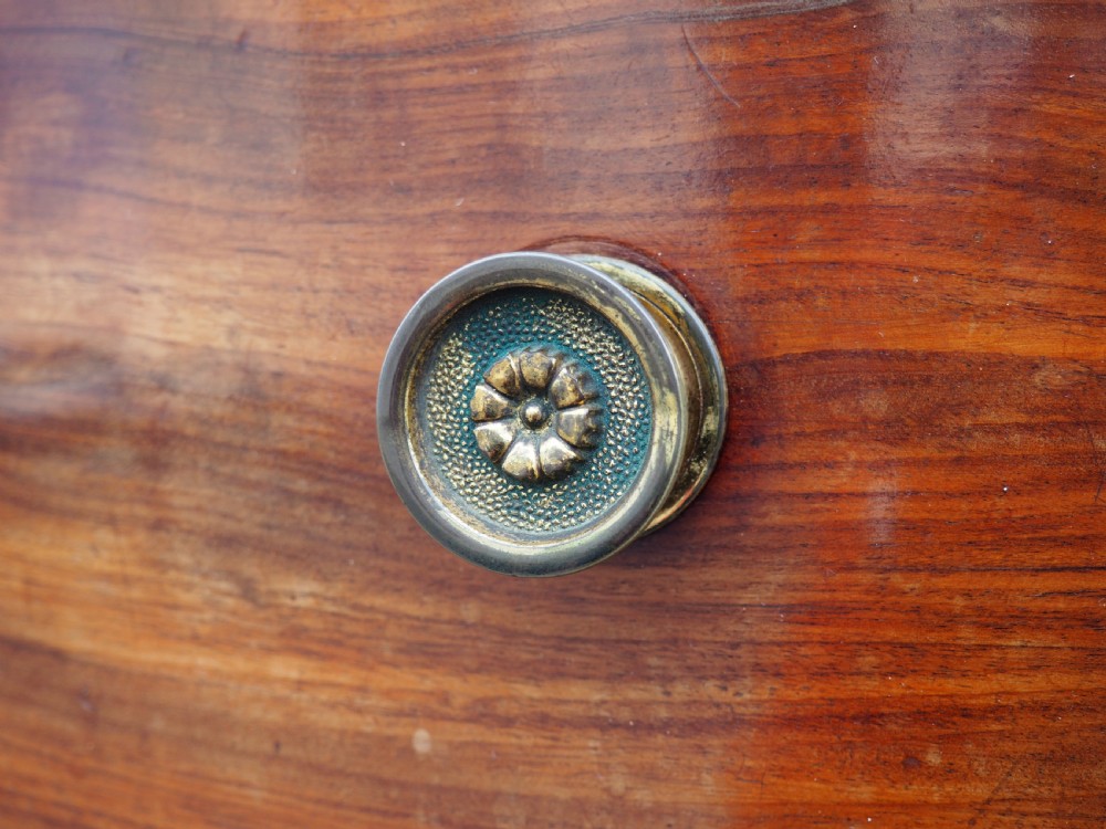 A Regency period mahogany bowfront chest of drawers featuring three full-width drawers, spiral-turned side columns, and circular brass handles. View III