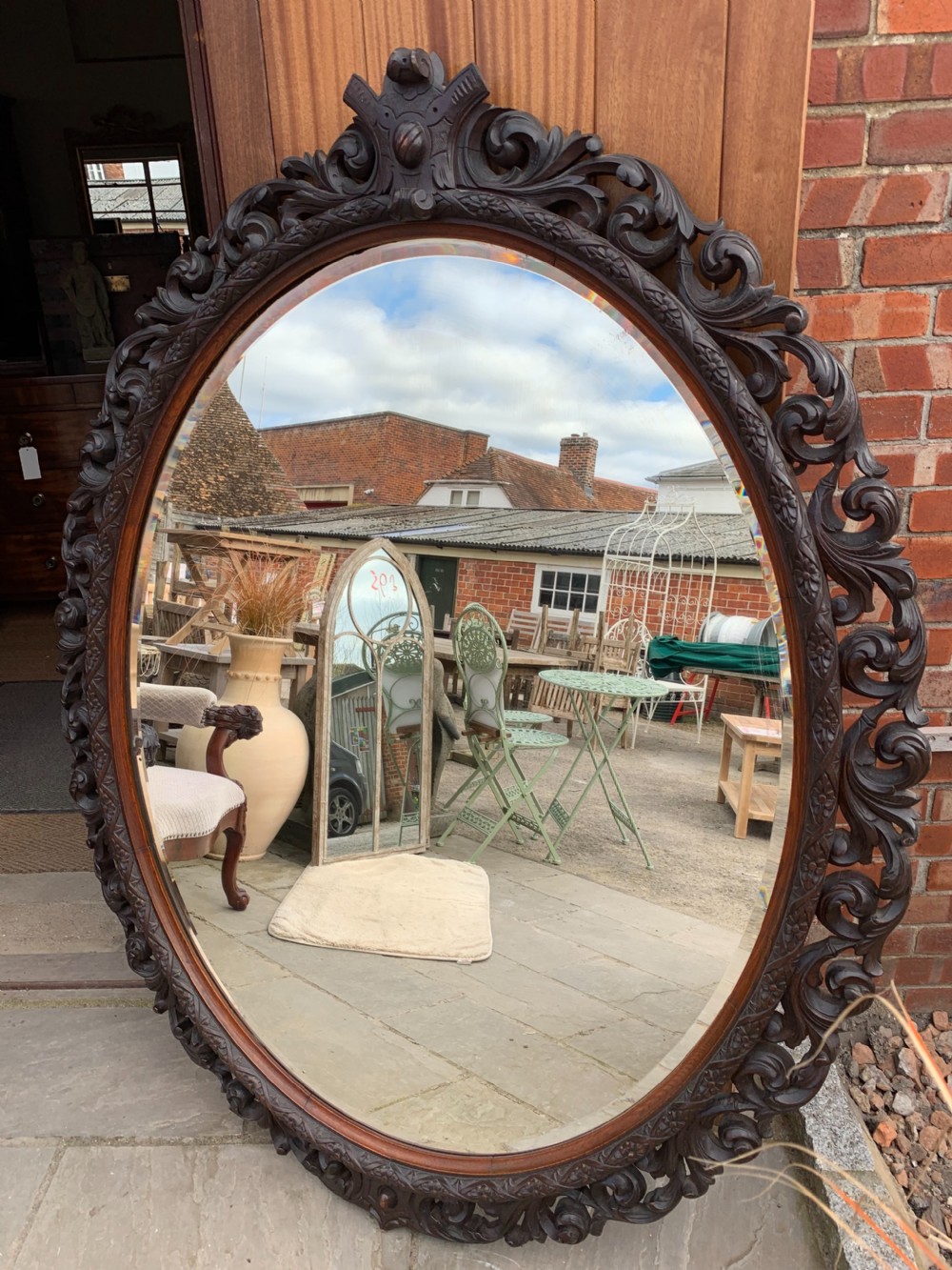 Very large carved Oak oval mirror 