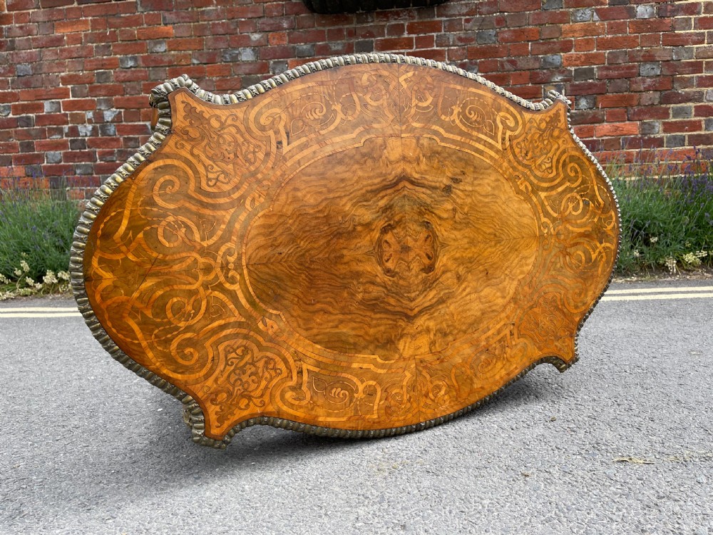 A 19th-century French style walnut centre table featuring a shaped serpentine top with floral marquetry inlay, slender cabriole legs, and ornate gilt bronze mounts. View V