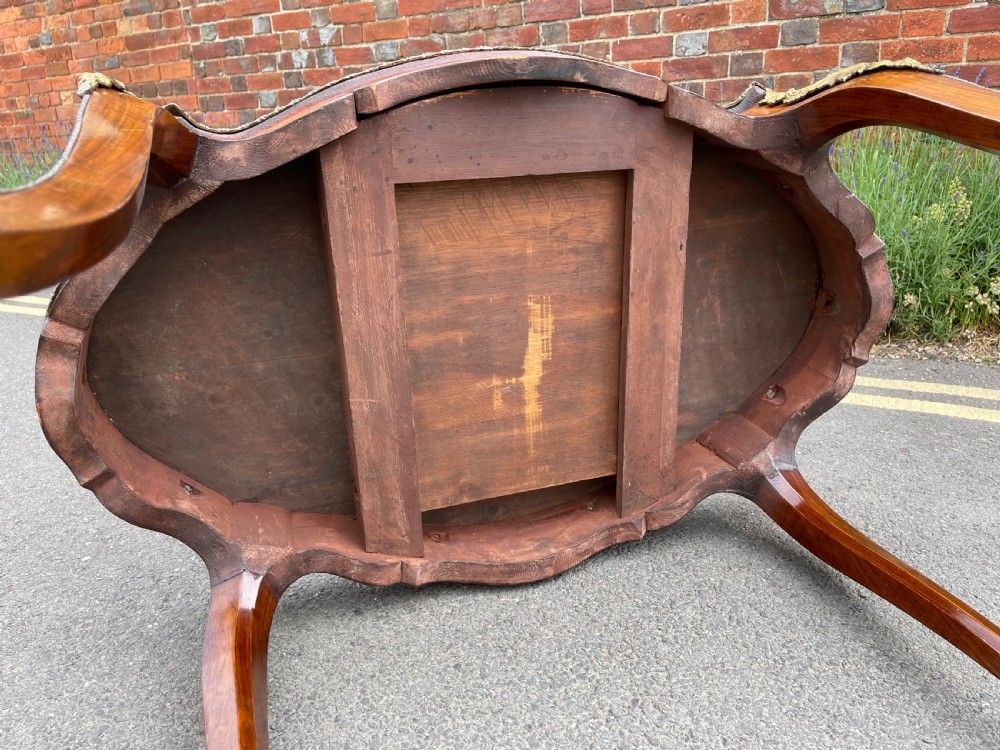 A 19th-century French style walnut centre table featuring a shaped serpentine top with floral marquetry inlay, slender cabriole legs, and ornate gilt bronze mounts. View VI