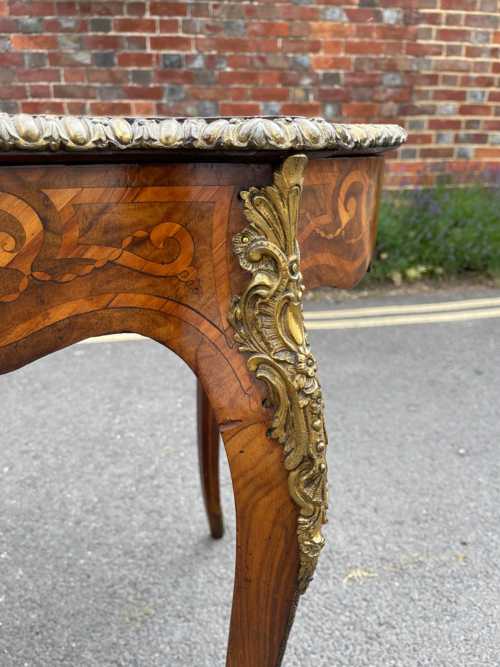 A 19th-century French style walnut centre table featuring a shaped serpentine top with floral marquetry inlay, slender cabriole legs, and ornate gilt bronze mounts. View VII