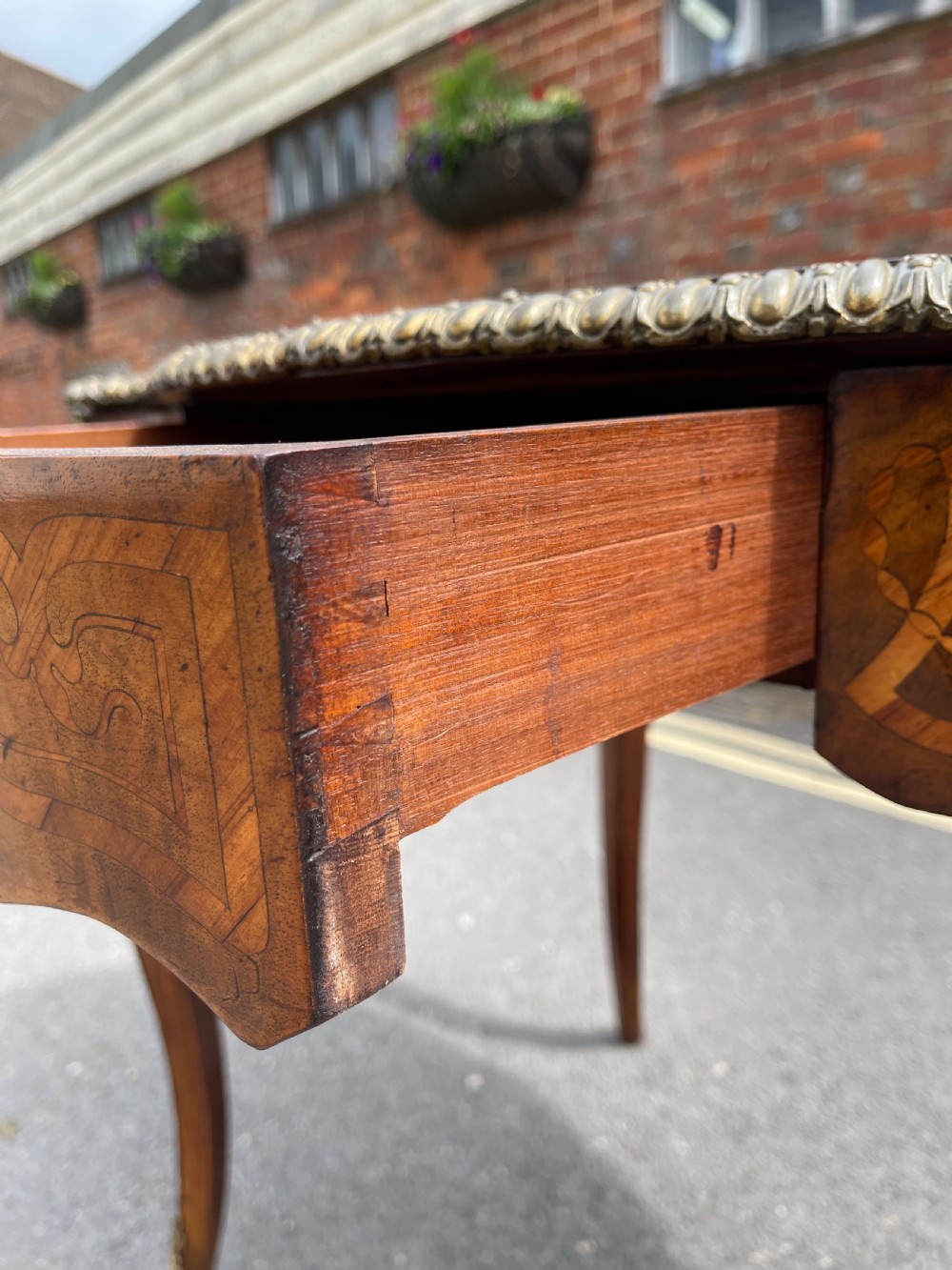 A 19th-century French style walnut centre table featuring a shaped serpentine top with floral marquetry inlay, slender cabriole legs, and ornate gilt bronze mounts. View VIII