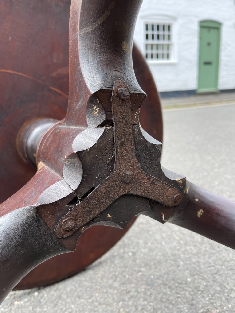 A George III mahogany three-tier dumb waiter featuring graduated circular trays supported by turned stem sections and a tripod base with pad feet. View II