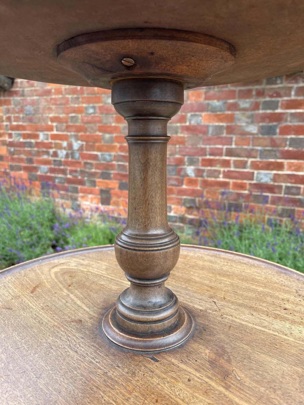 A George III mahogany three-tier dumb waiter featuring graduated circular trays supported by turned stem sections and a tripod base with pad feet. View VIII