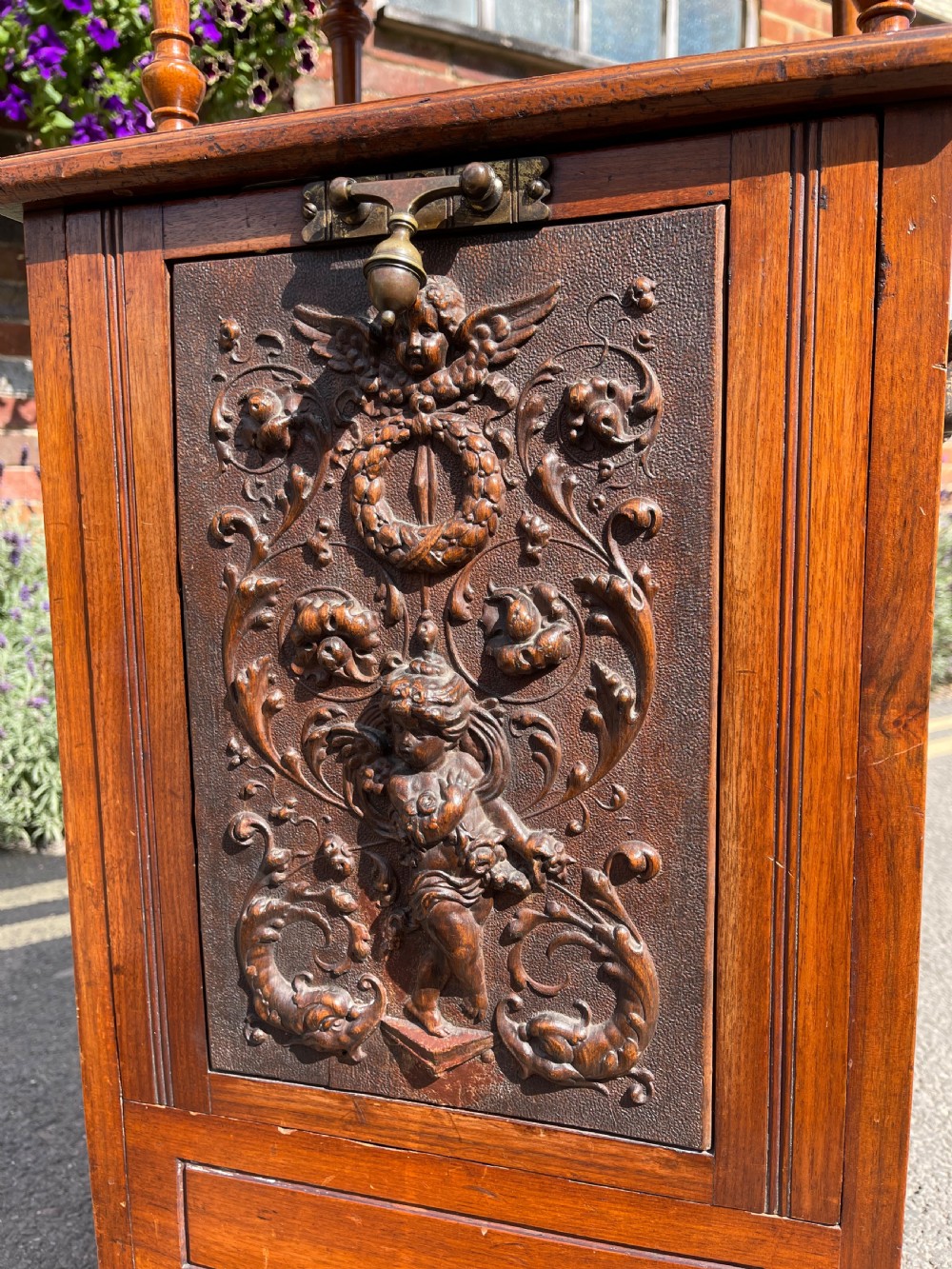 Victorian walnut purdonium featuring an upper shelf on turned spindles with a brass gallery above a carved drop-front compartment. View V