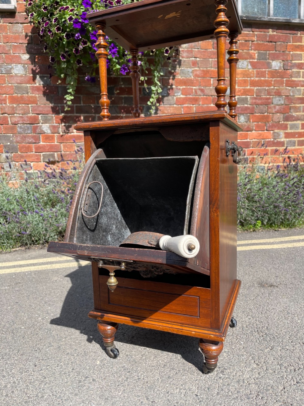 Victorian walnut purdonium featuring an upper shelf on turned spindles with a brass gallery above a carved drop-front compartment. View VI