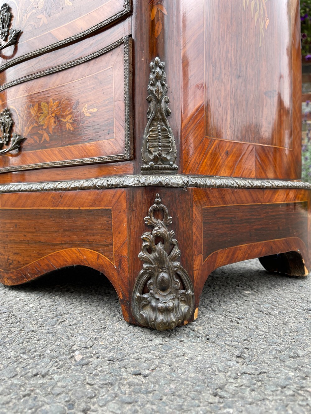 A tall, narrow 19th-century French rosewood semainier chest featuring seven drawers with floral marquetry inlay, bronze handles, and a marble top. View II