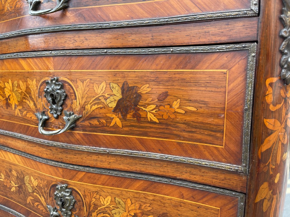 A tall, narrow 19th-century French rosewood semainier chest featuring seven drawers with floral marquetry inlay, bronze handles, and a marble top. View III