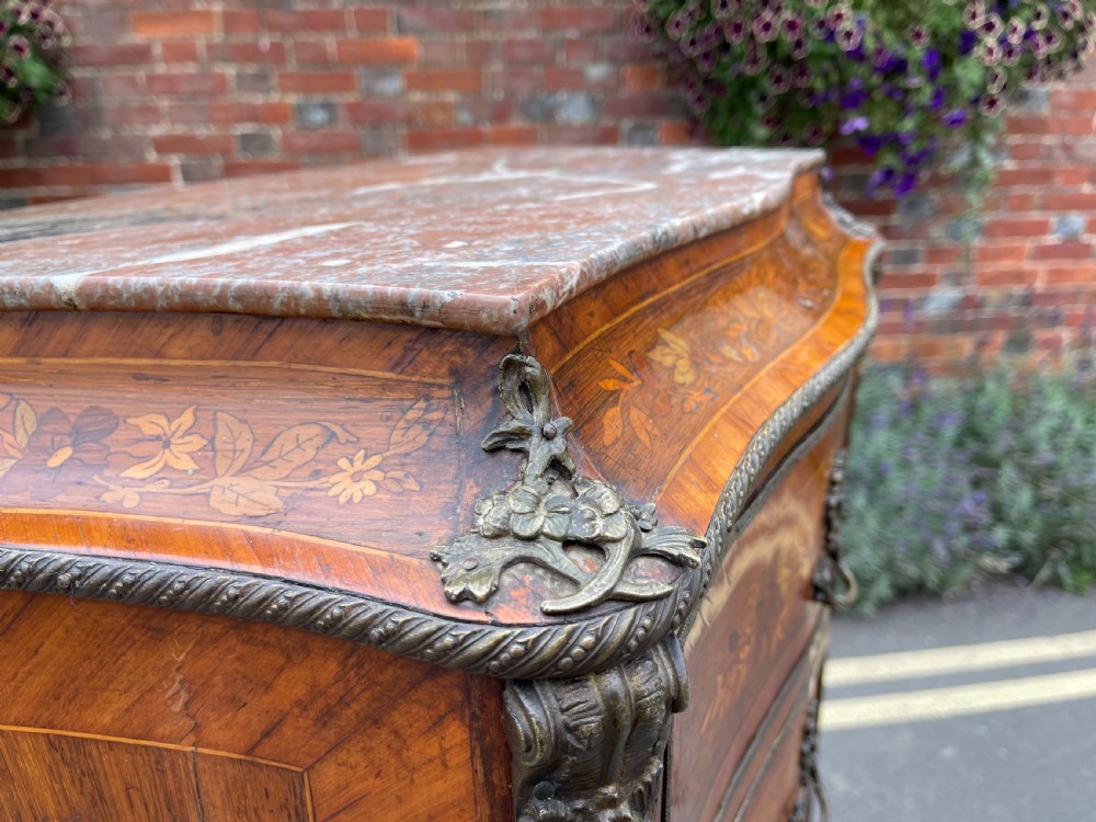 A tall, narrow 19th-century French rosewood semainier chest featuring seven drawers with floral marquetry inlay, bronze handles, and a marble top. View VI