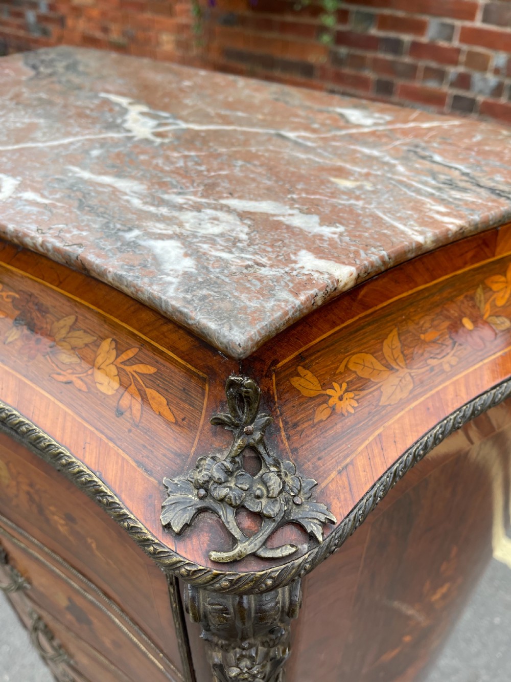 A tall, narrow 19th-century French rosewood semainier chest featuring seven drawers with floral marquetry inlay, bronze handles, and a marble top. View X