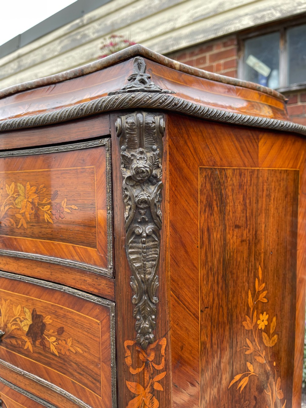 A tall, narrow 19th-century French rosewood semainier chest featuring seven drawers with floral marquetry inlay, bronze handles, and a marble top. View XI