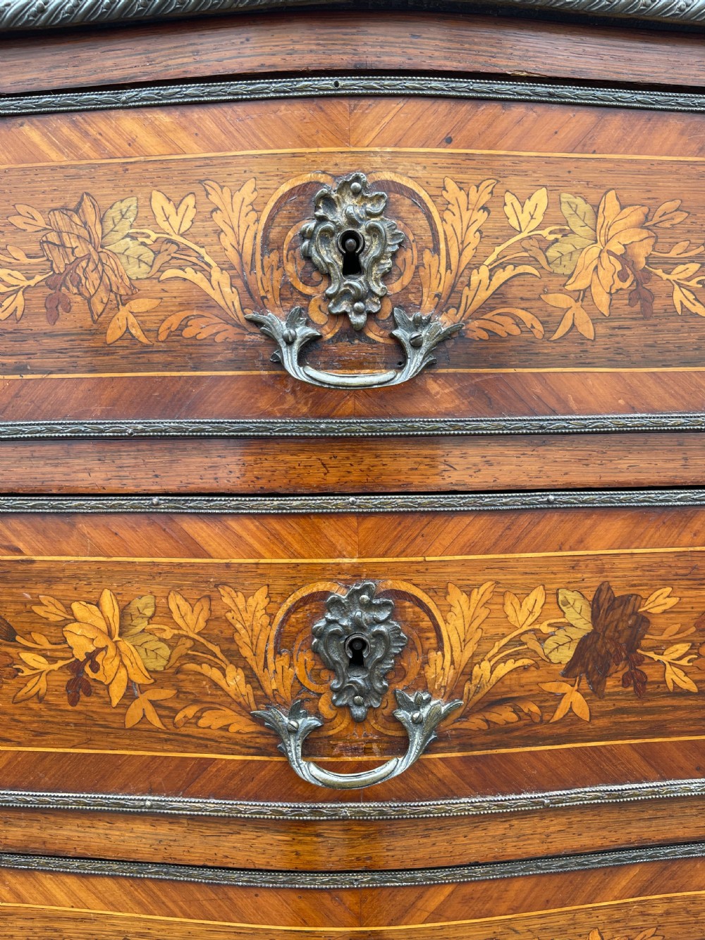 A tall, narrow 19th-century French rosewood semainier chest featuring seven drawers with floral marquetry inlay, bronze handles, and a marble top. View XII