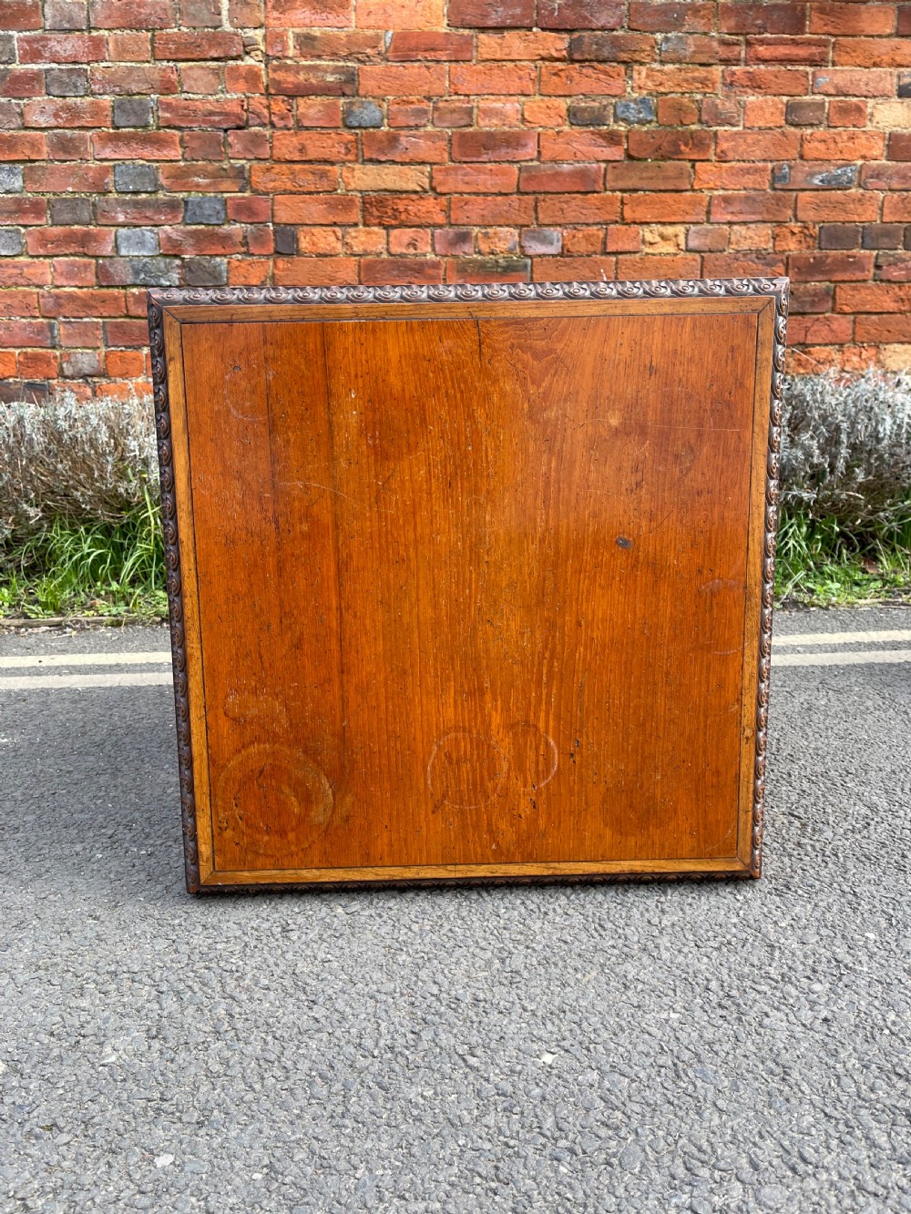 An Anglo-Indian carved wood revolving bookcase featuring vertical foliate slats and a tiered pedestal base. View V