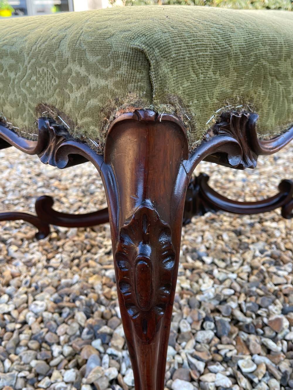 A nineteenth-century rosewood footstool featuring carved cabriole legs and a textured green fabric upholstered top. View II
