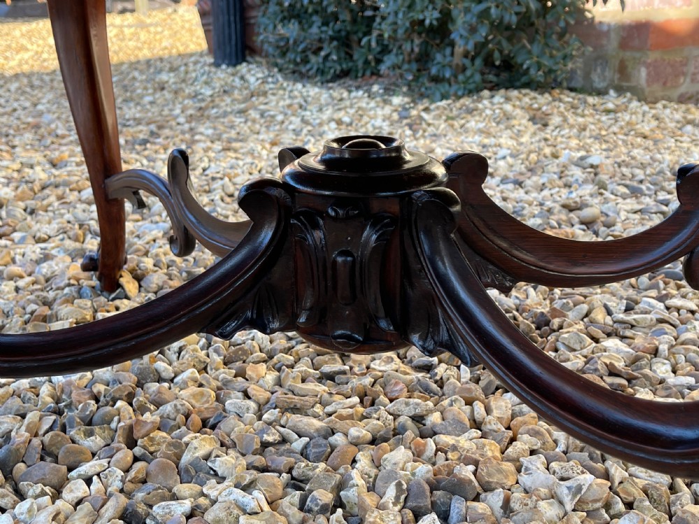 A nineteenth-century rosewood footstool featuring carved cabriole legs and a textured green fabric upholstered top. View III