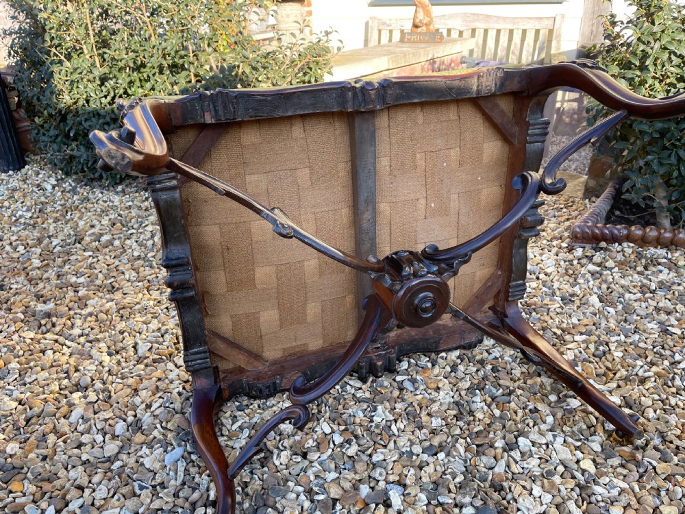 A nineteenth-century rosewood footstool featuring carved cabriole legs and a textured green fabric upholstered top. View IV