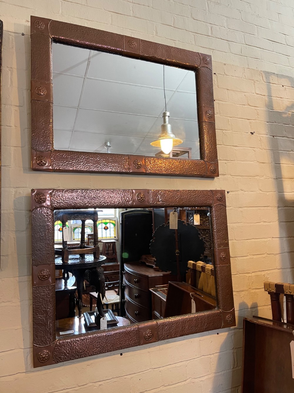 Pair of arts and crafts copper mirrors 