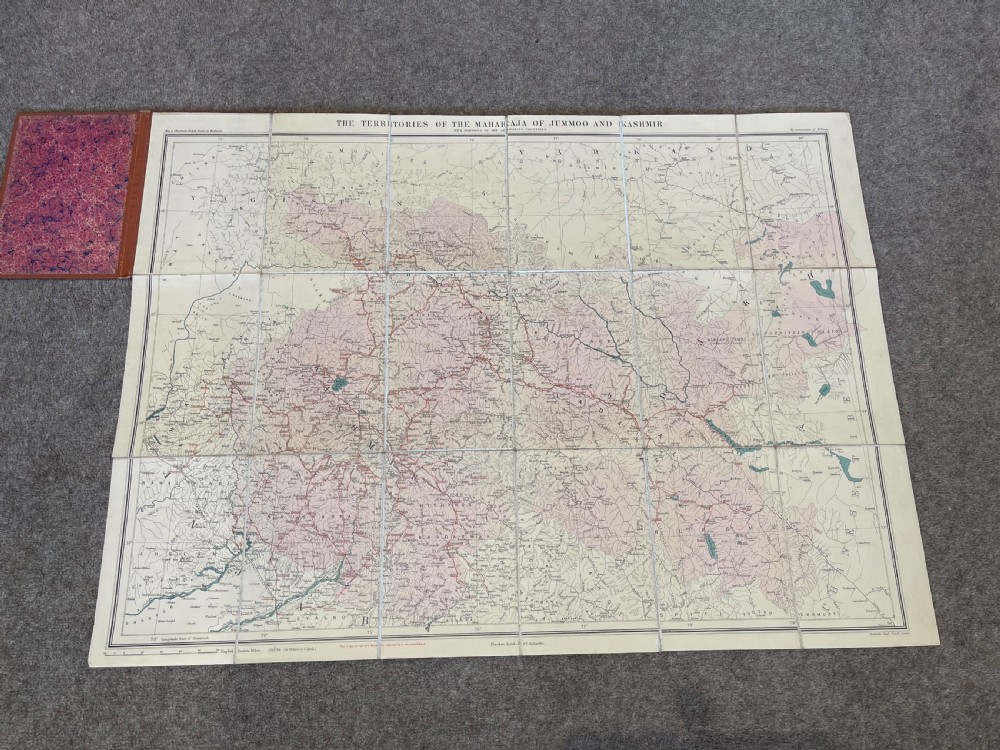 An antique terracotta cloth-bound cover for Thackers Map of Jummoo and Kashmir featuring gilt-embossed lettering and a debossed border. View II
