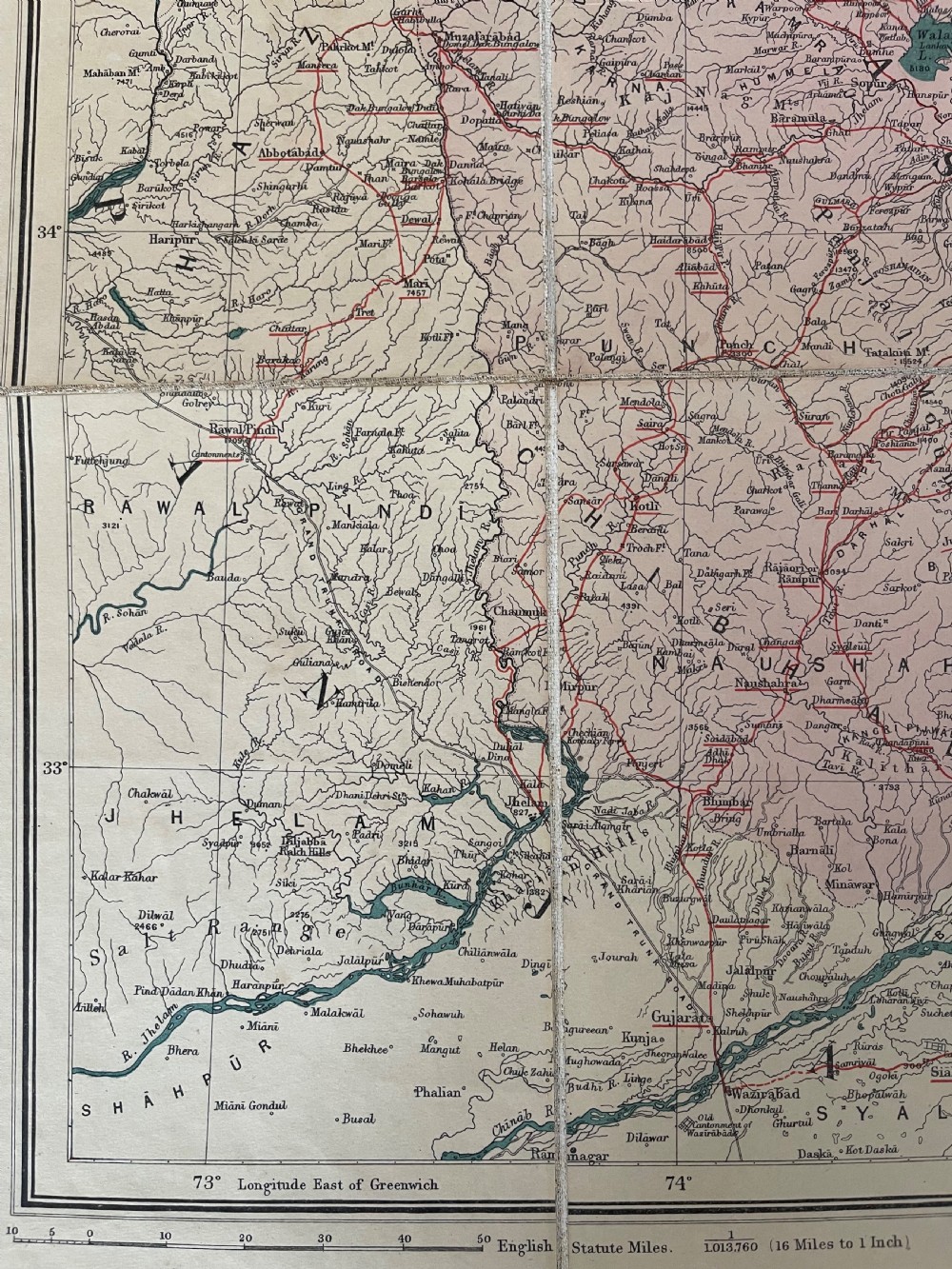 An antique terracotta cloth-bound cover for Thackers Map of Jummoo and Kashmir featuring gilt-embossed lettering and a debossed border. View V