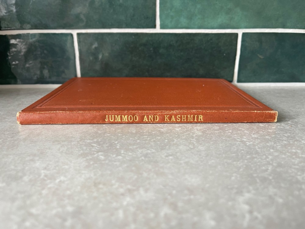 An antique terracotta cloth-bound cover for Thackers Map of Jummoo and Kashmir featuring gilt-embossed lettering and a debossed border. View VIII