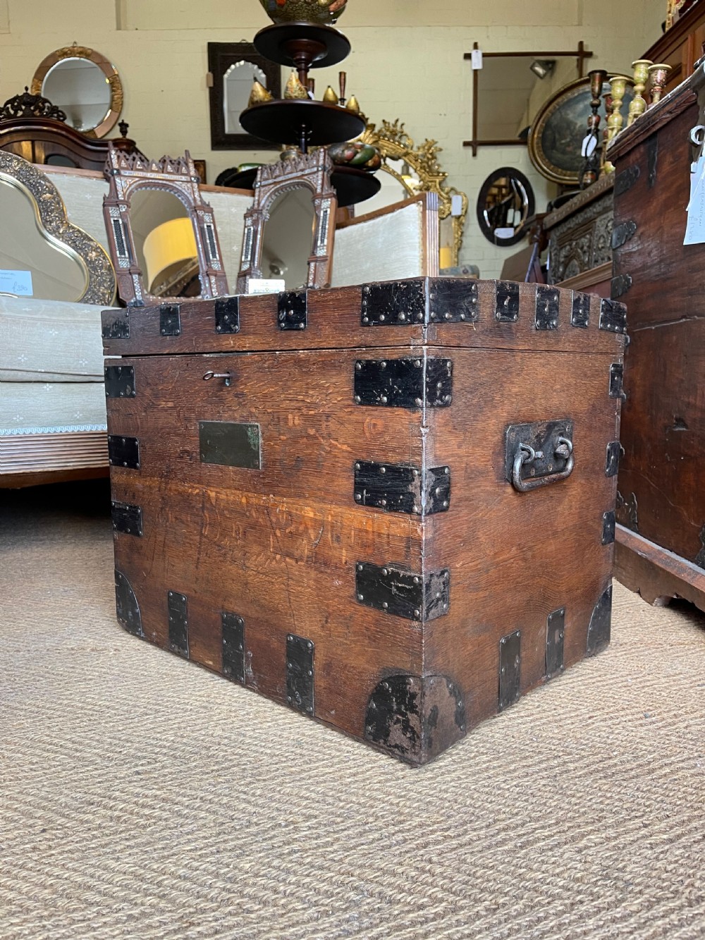 A nineteenth-century oak silver chest featuring metal corner brackets, iron strap bindings, and a central brass plate. View VIII
