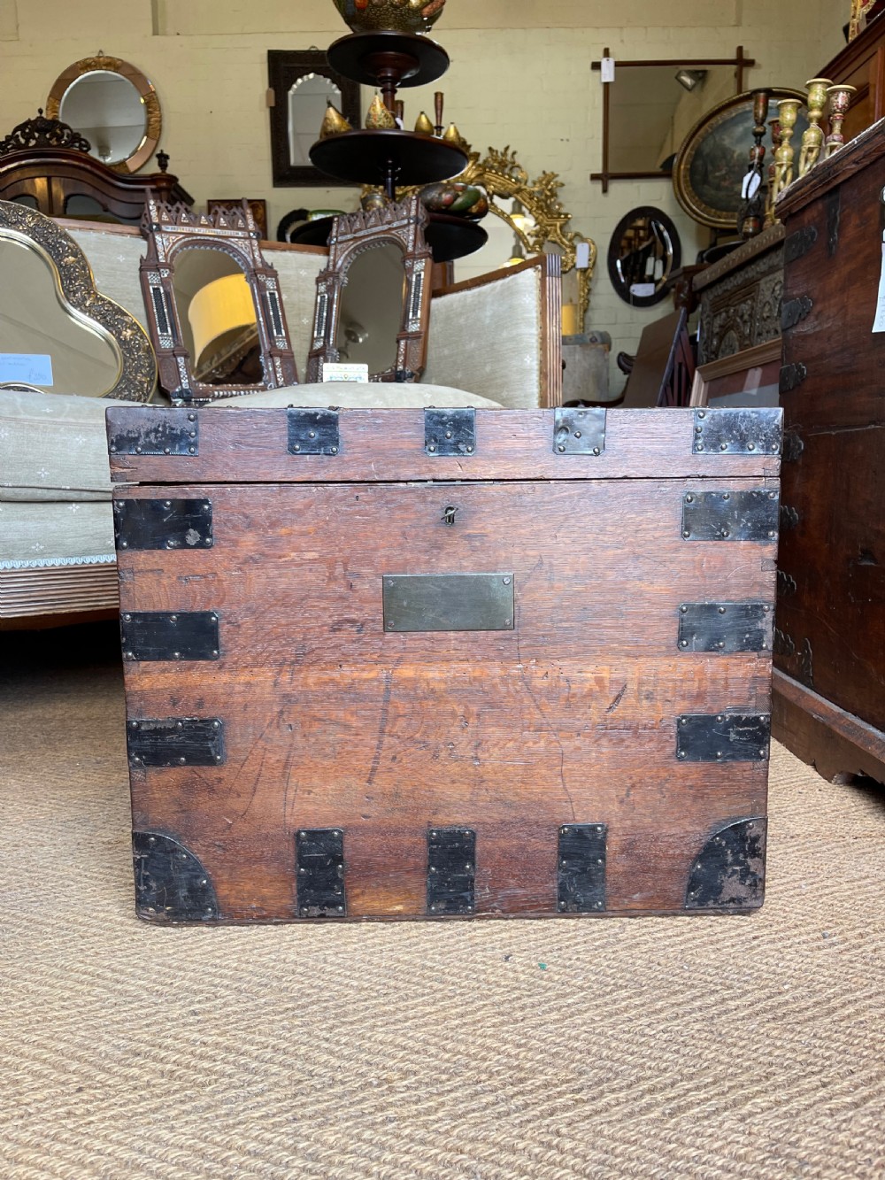 A nineteenth-century oak silver chest featuring metal corner brackets, iron strap bindings, and a central brass plate. View XII