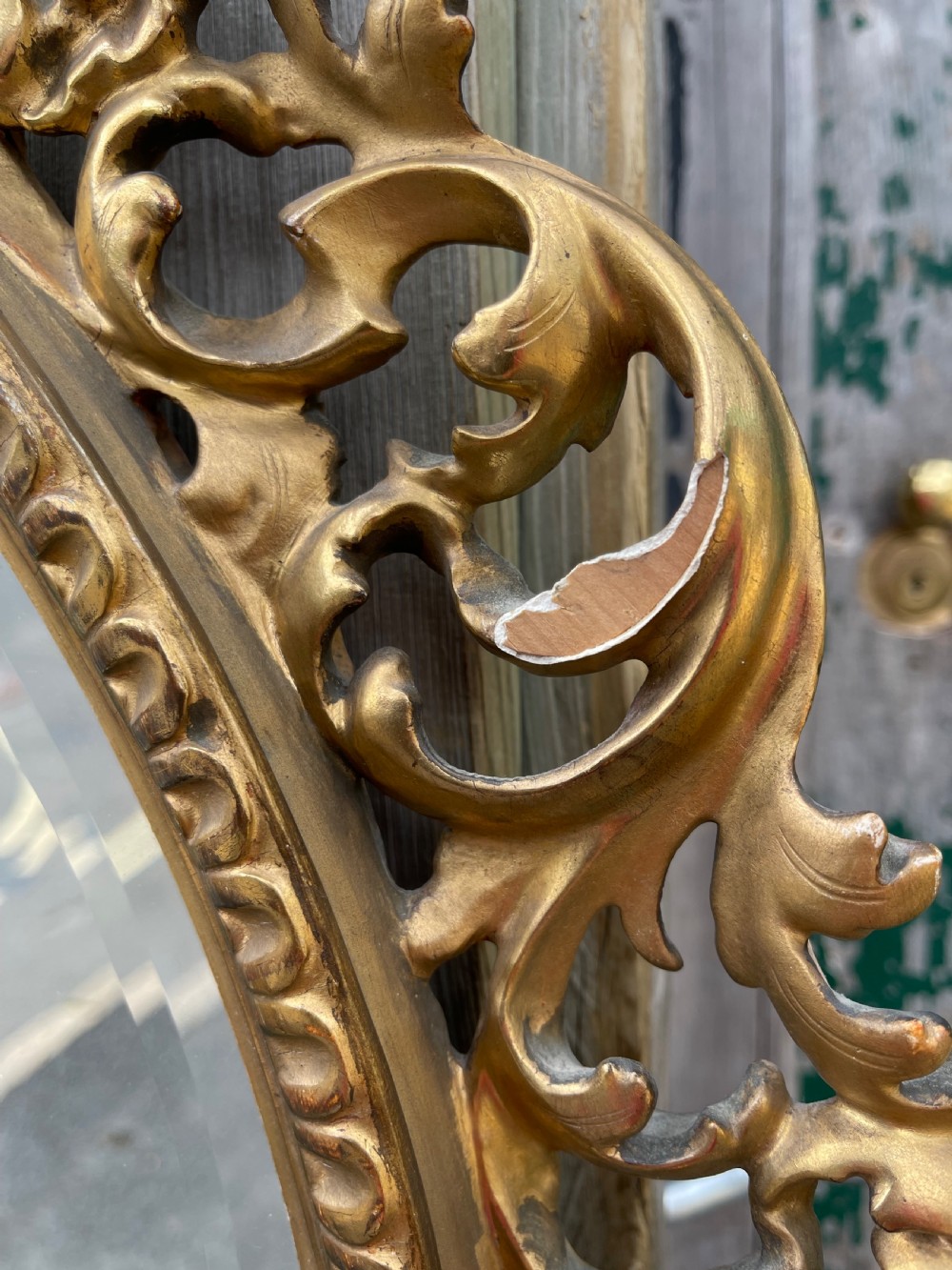 A matching pair of circular wall mirrors featuring elaborate carved giltwood frames decorated with scrollwork and shell motifs. View IV