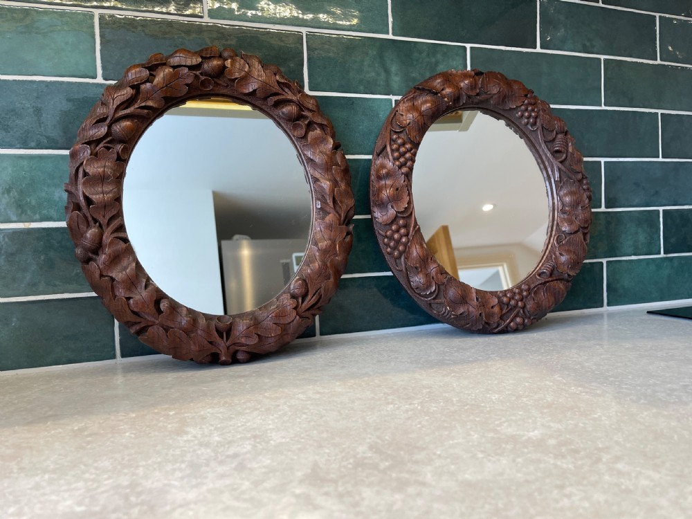 Pair of small carved oak mirrors 