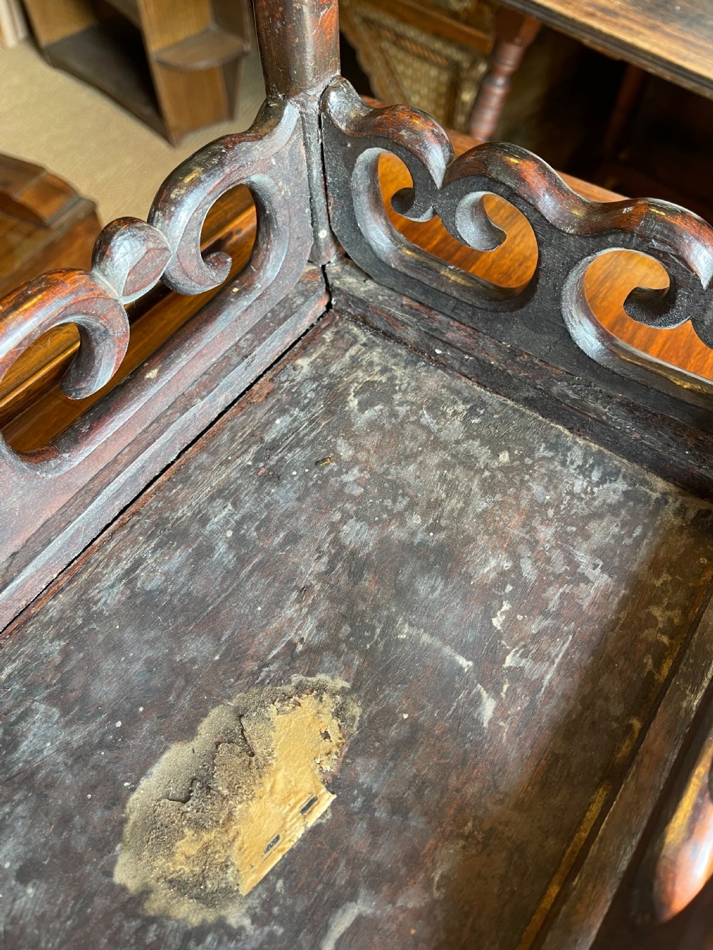 A set of four graduated dark hardwood nesting tables featuring pierced openwork aprons and bamboo-form carved legs. View IV