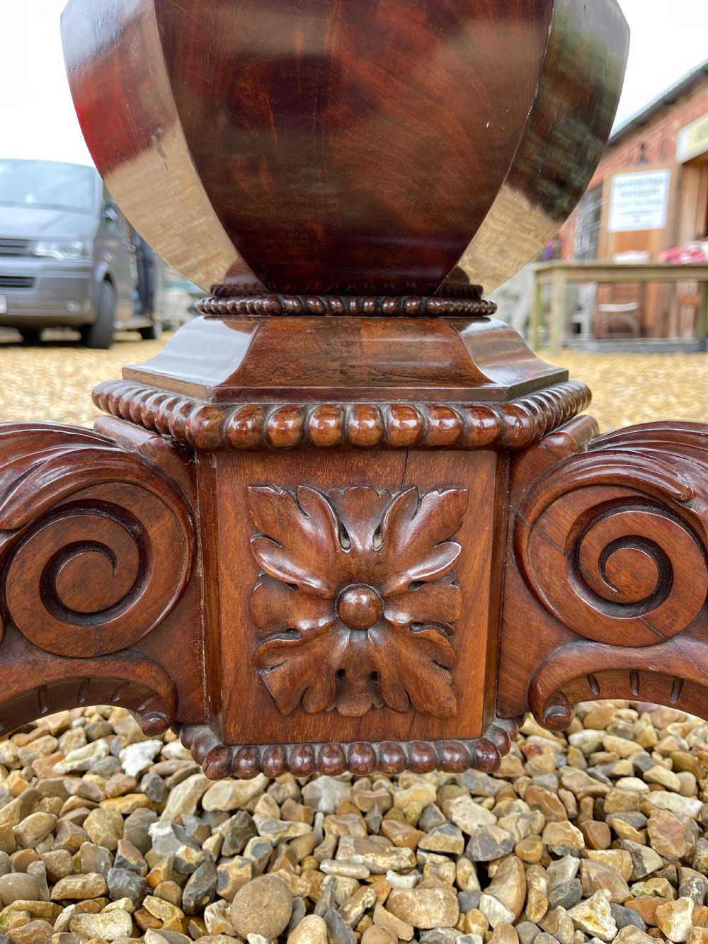 A circular nineteenth-century mahogany centre table featuring a geometric specimen marble mosaic top bordered by a Greek key pattern, supported by a carved pedestal base. View V