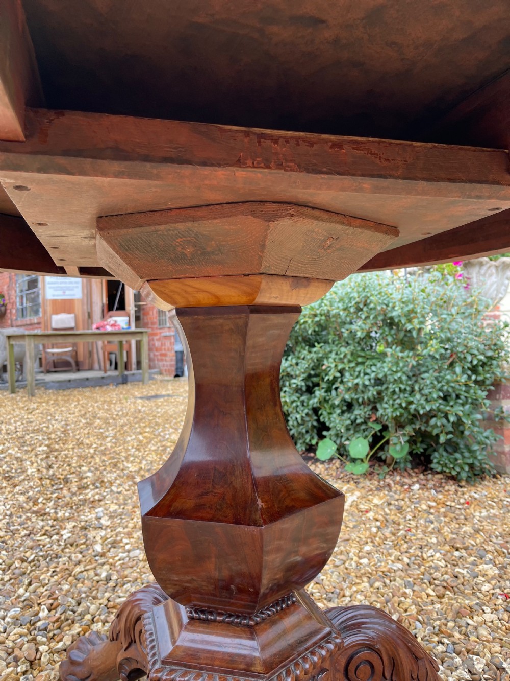 A circular nineteenth-century mahogany centre table featuring a geometric specimen marble mosaic top bordered by a Greek key pattern, supported by a carved pedestal base. View IX