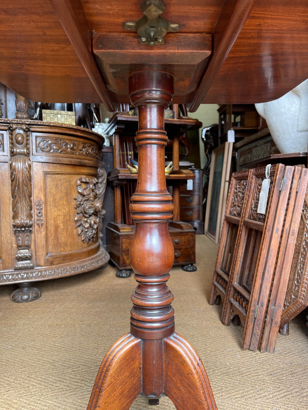 A Georgian mahogany tilt top table displayed vertically, featuring a rectangular top, turned central column, and reeded tripod legs. View III