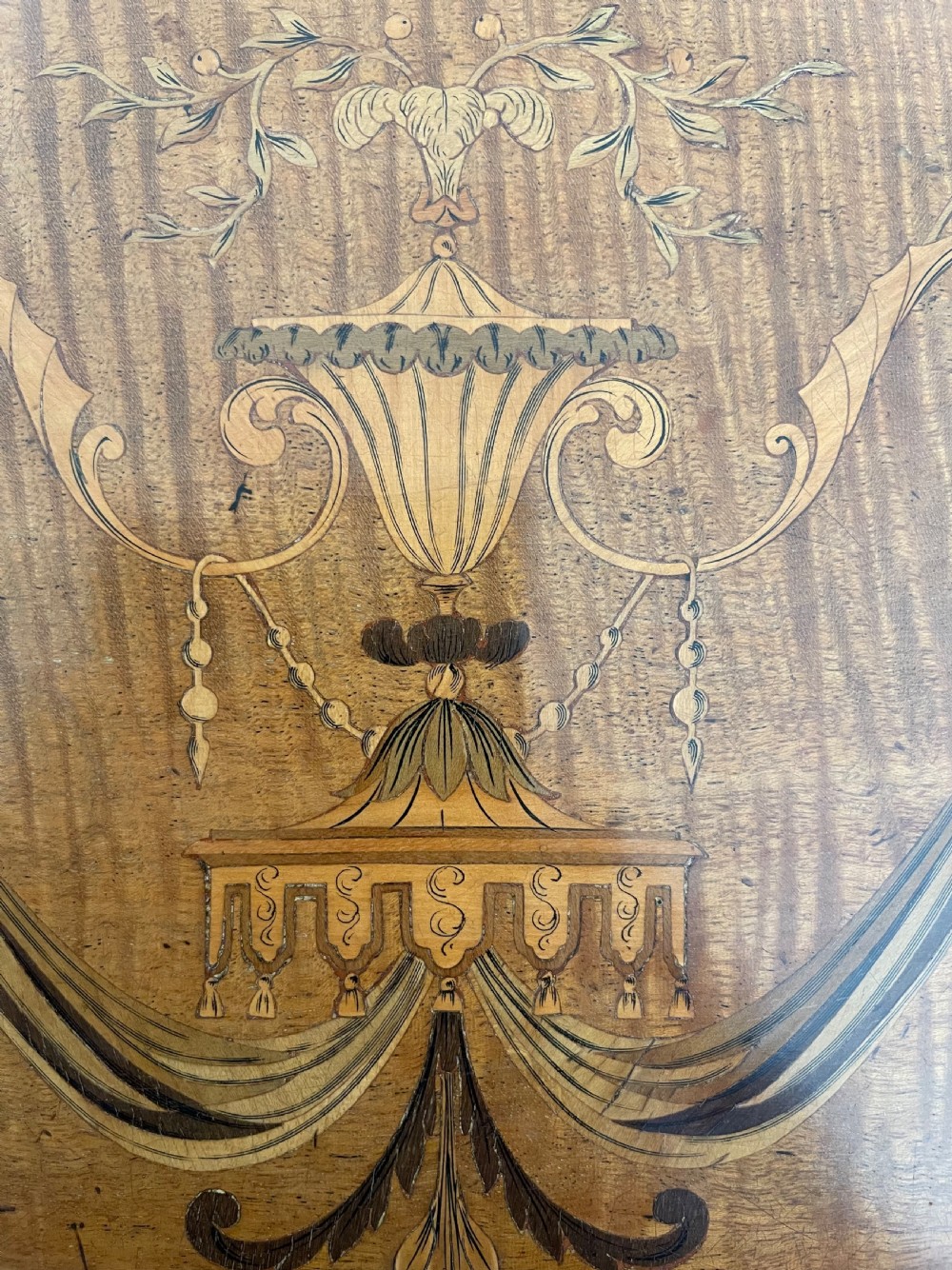 An oval antique mahogany Pembroke table with detailed marquetry inlay, drop leaves, and tapered legs. View VI