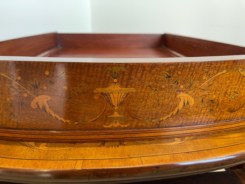 An oval antique mahogany Pembroke table with detailed marquetry inlay, drop leaves, and tapered legs. View IX