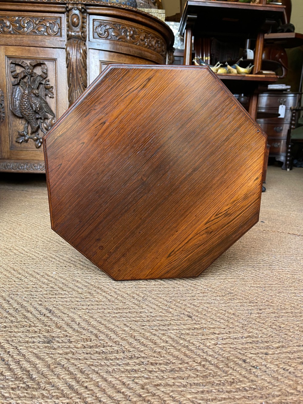A nineteenth-century rosewood revolving book table featuring an octagonal top, pierced fretwork gallery compartments, turned central column, and four swept legs. View IV