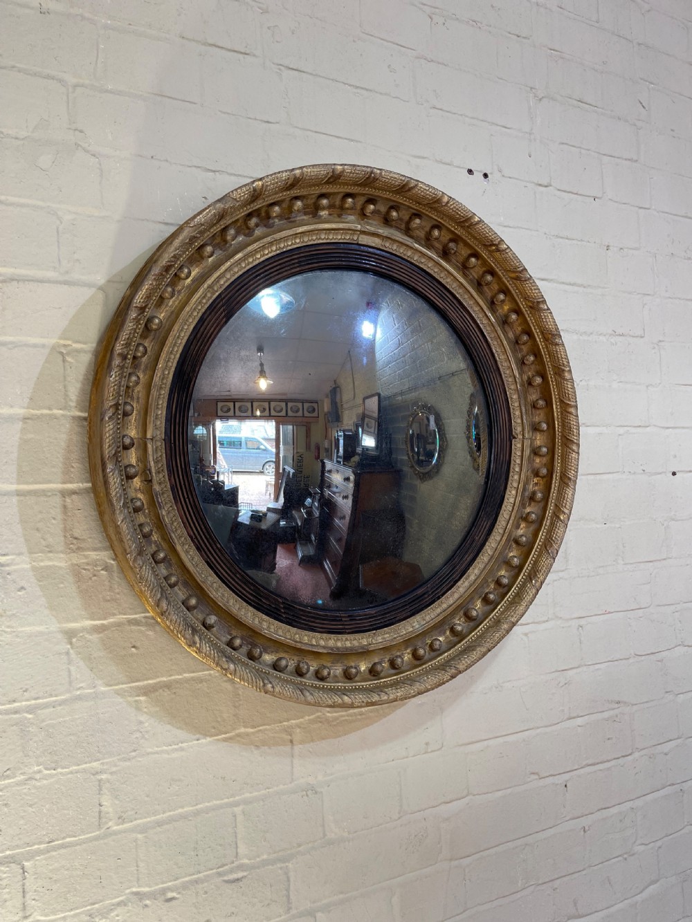 Early Nineteenth Century giltwood convex mirror 