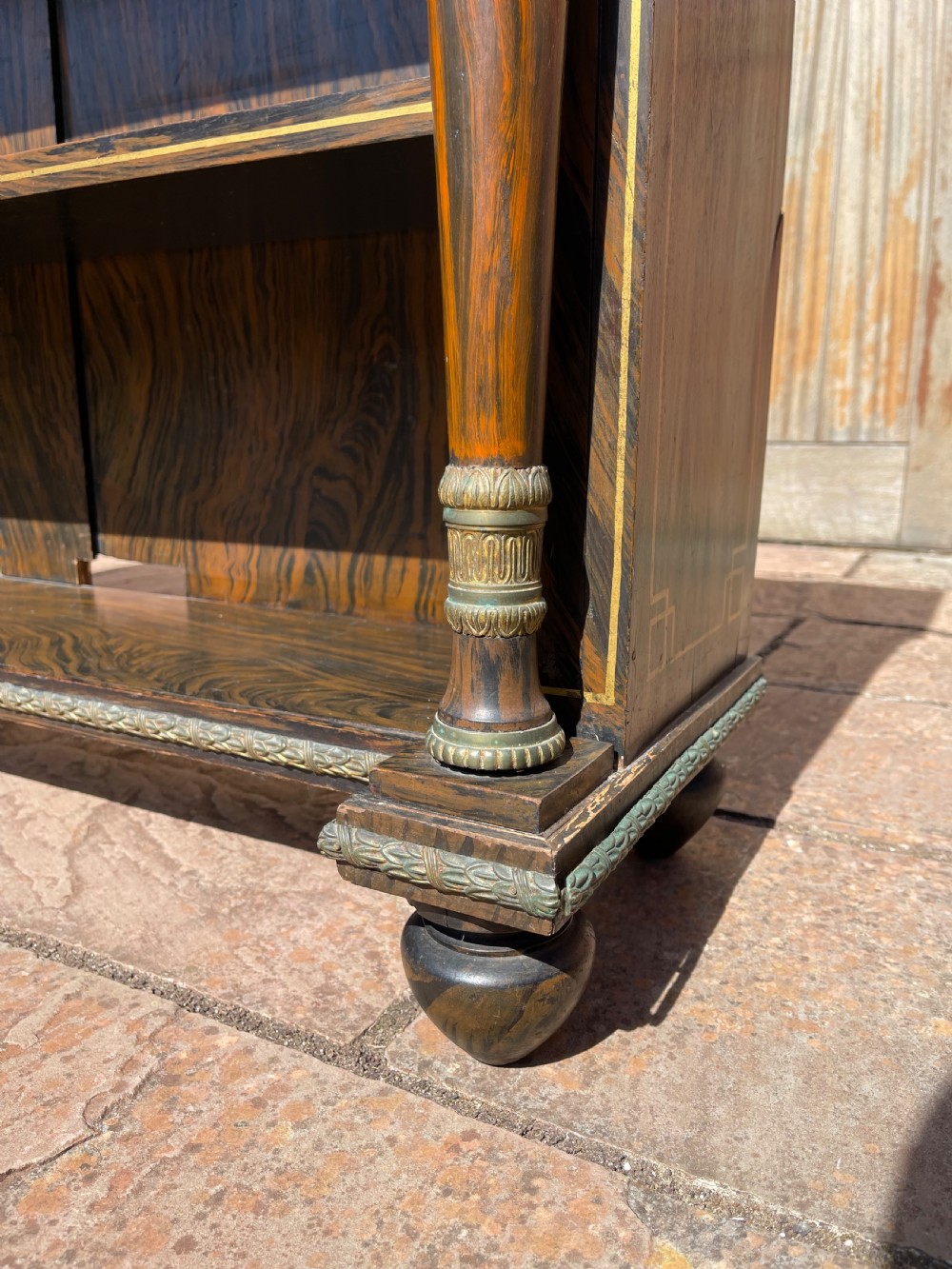 An early nineteenth-century open bookcase featuring a simulated rosewood painted finish, green marble top, gilt star motifs, and turned side columns. View III